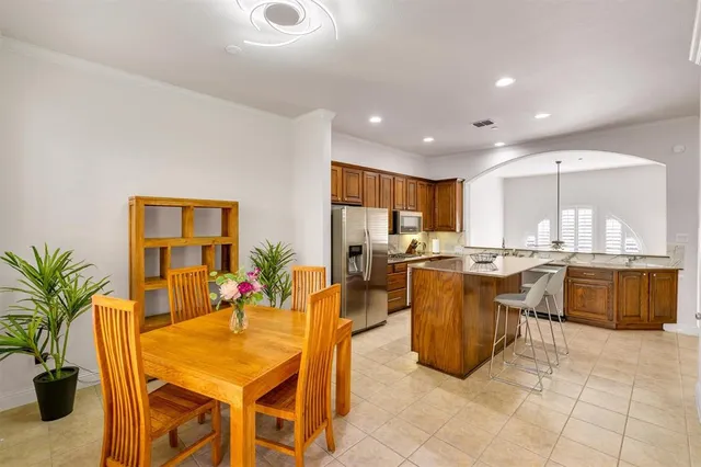 a living room with furniture a rug and kitchen view