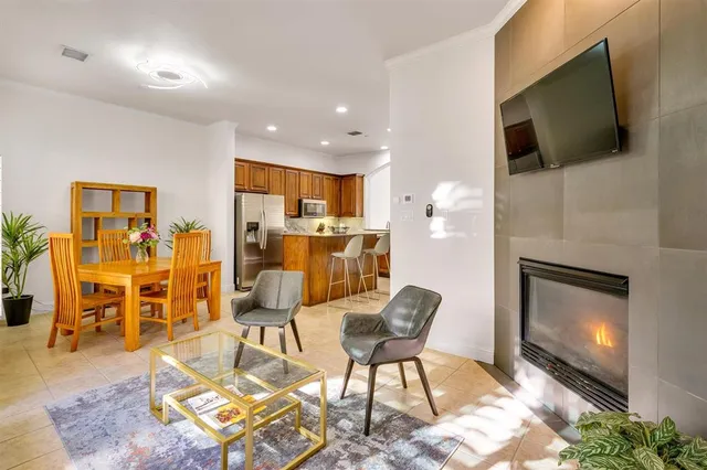 a living room with furniture fireplace and window