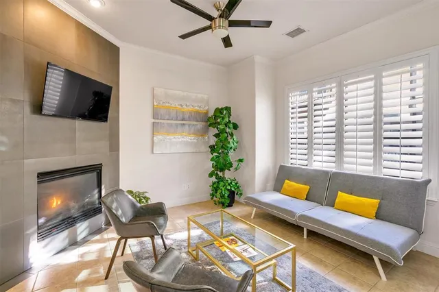 a bedroom with a bed and a large window with a chandelier