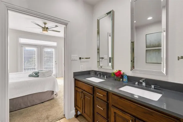 a bathroom with a granite countertop sink and a toilet