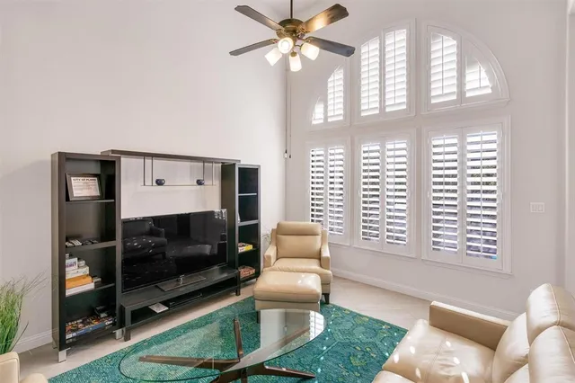 a living room with a table and a mirror