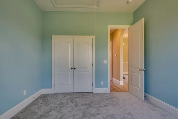 an empty room with closet area