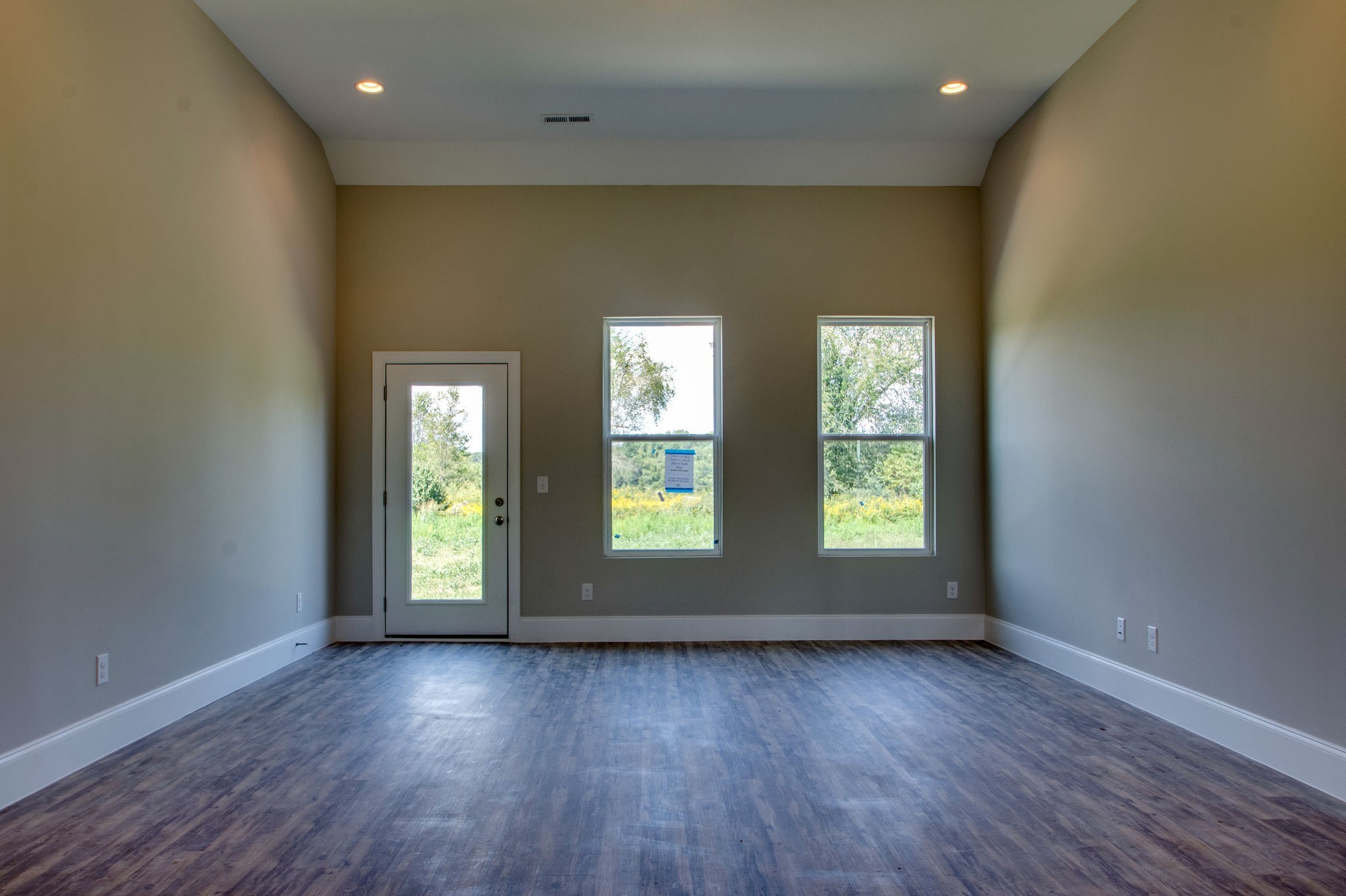 946 Hunters Lane Springfield, TN 37172 - Photo 6 of 24 an empty room with wooden floor and windows