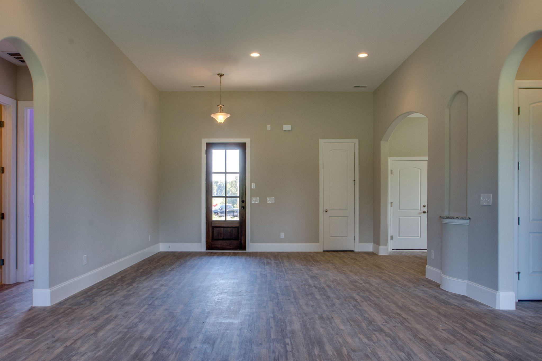 946 Hunters Lane Springfield, TN 37172 - Photo 7 of 24 an empty room with wooden floor and windows