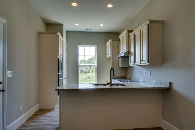 a view of room with window and wooden floor