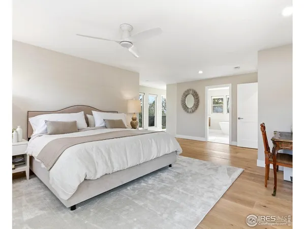 a bedroom with bed and wooden floor