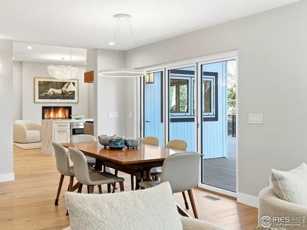 a dining room with furniture a chandelier and wooden floor
