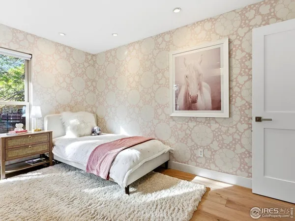 a spacious bedroom with a bed and a cabinets