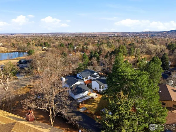an aerial view of house yard and mountain view in back