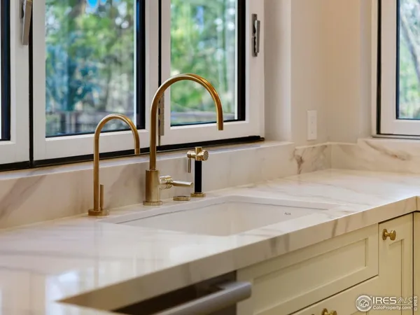 a view of a bathroom sink with a window