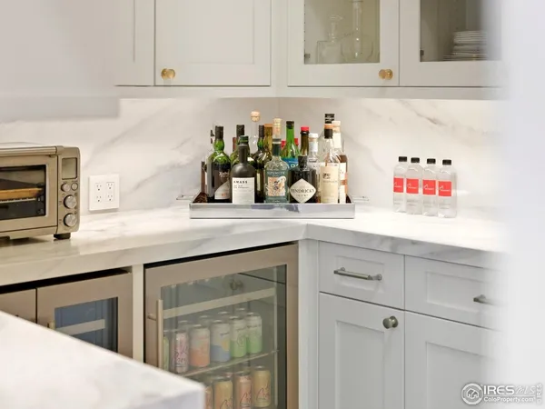 a kitchen with white cabinets and sink