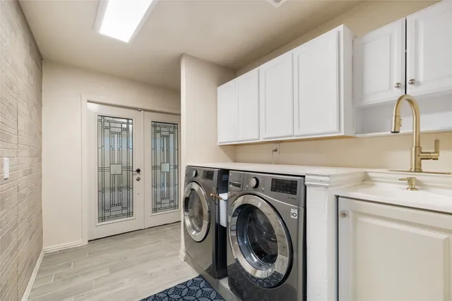 a utility room with sink dryer and washer