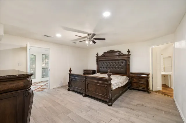 a bed room with a bed and a ceiling fan