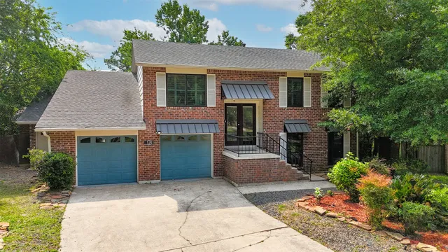 a front view of a house with a garden