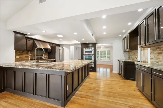 a kitchen with stainless steel appliances granite countertop a large counter top and stove