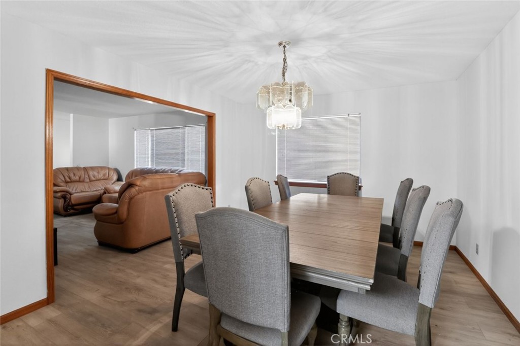18539 Symeron Road Apple Valley, CA 92307 - Photo 20 of 30 a view of a dining room with furniture and wooden floor