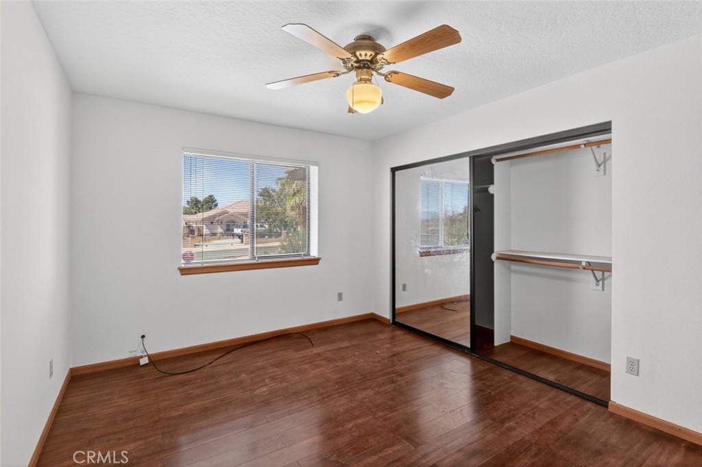 18539 Symeron Road Apple Valley, CA 92307 - Photo 22 of 30 a view of an empty room with wooden floor