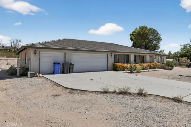 a front view of a house with a yard and a garage