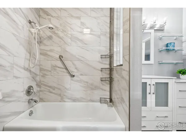 a bathroom with a bathtub and shower