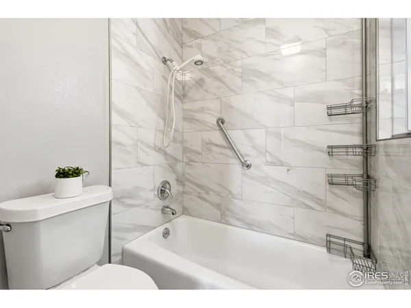 a view of a livingroom with bathroom and shower