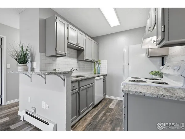 a kitchen with a stove cabinets and a sink