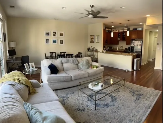 a living room with furniture and kitchen view