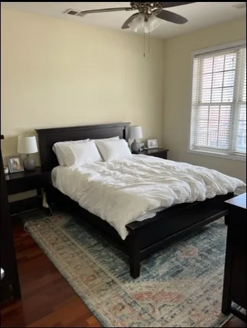 a bed sitting in a bedroom next to a window