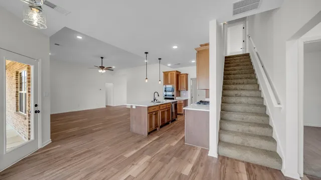 a bathroom with a granite countertop sink mirror and toilet