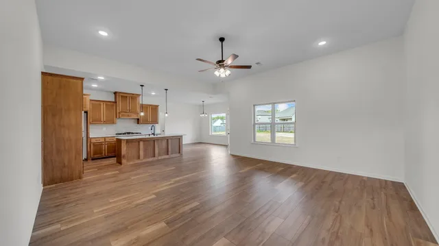 a kitchen with stainless steel appliances granite countertop a sink and a white cabinets