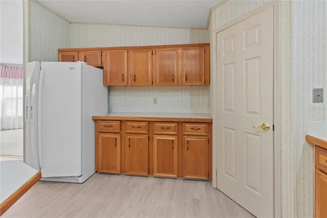 a view of a kitchen with dining table and chairs