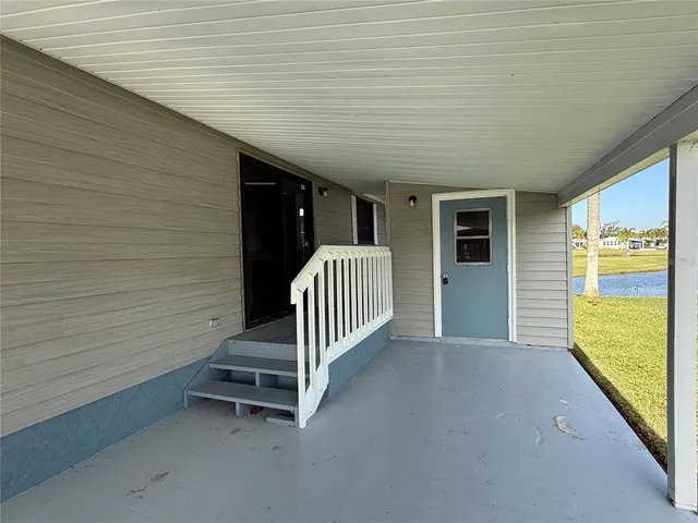 a view of a porch with wooden floor and fence