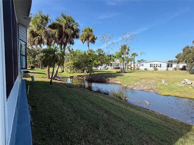 a view of backyard of house with green space