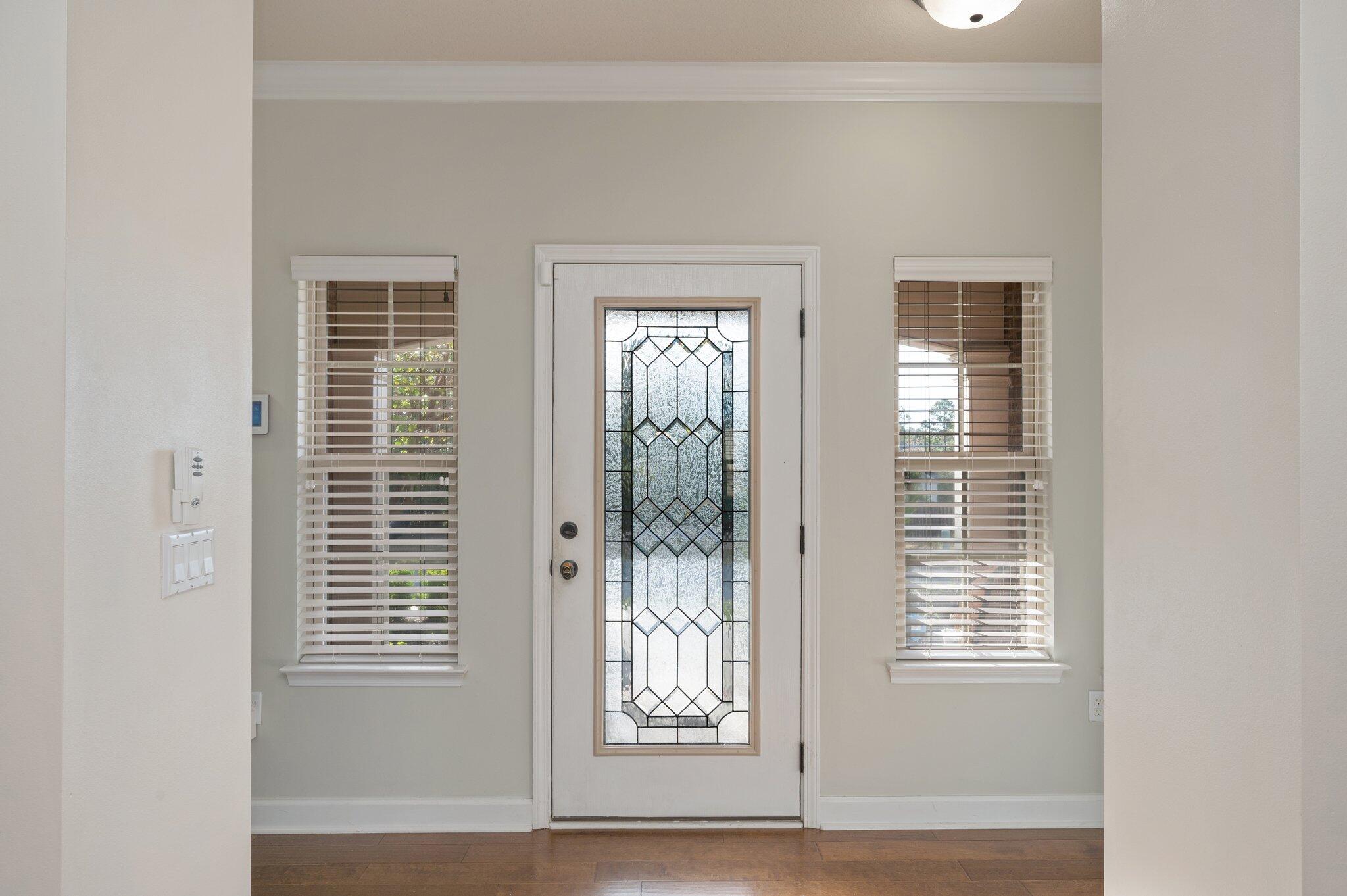 4434 Mirada Way Crestview, FL 32539 - Photo 14 of 42 a view of an empty room with wooden floor and a window