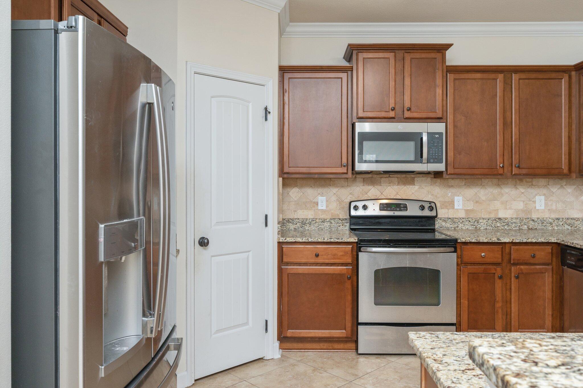 4434 Mirada Way Crestview, FL 32539 - Photo 21 of 42 a kitchen with stainless steel appliances granite countertop a stove microwave and refrigerator
