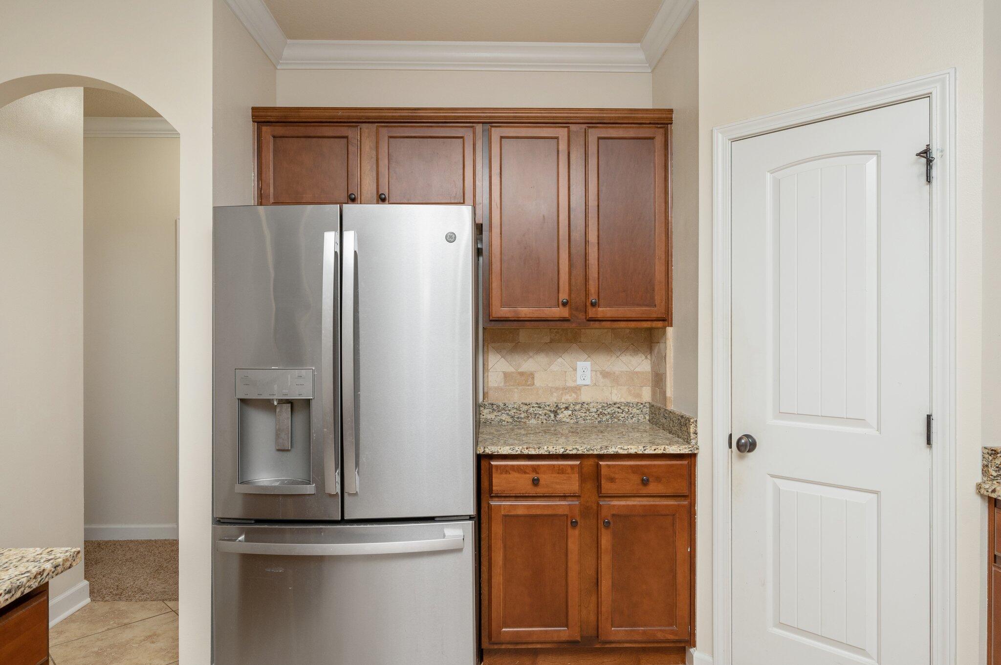 4434 Mirada Way Crestview, FL 32539 - Photo 24 of 42 a metallic refrigerator freezer sitting in a kitchen