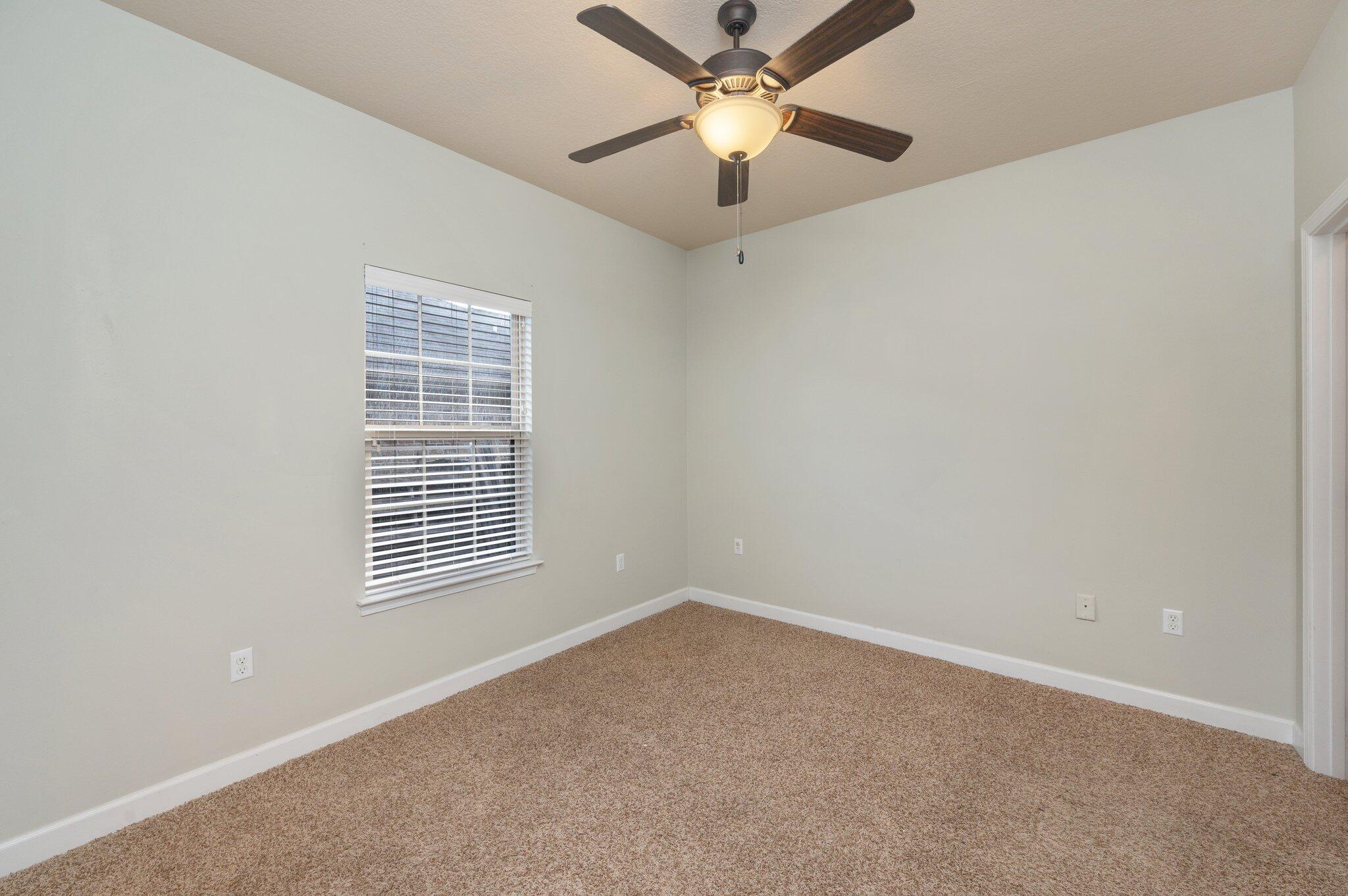 4434 Mirada Way Crestview, FL 32539 - Photo 26 of 42 an empty room with a window and a fan