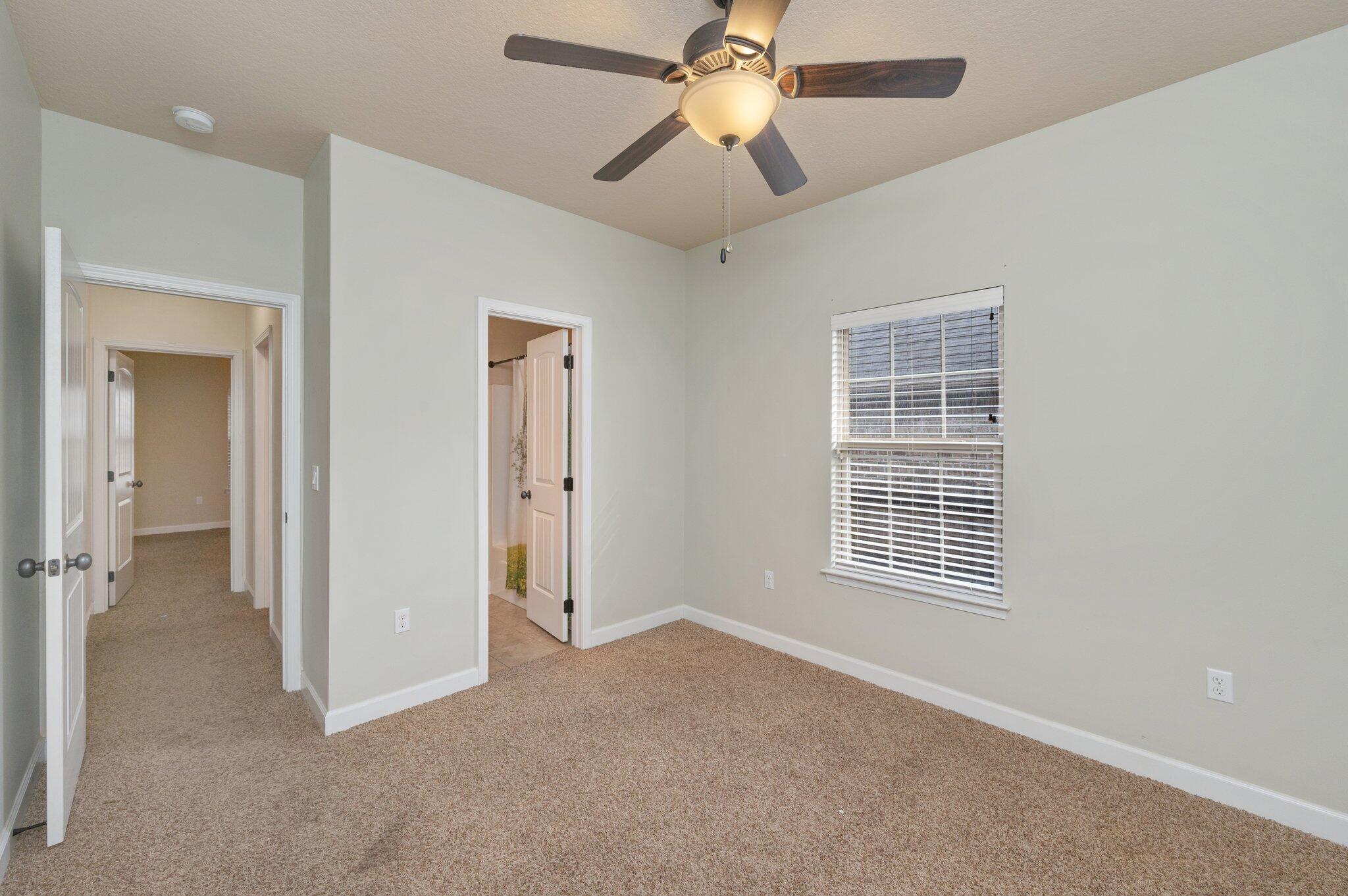 4434 Mirada Way Crestview, FL 32539 - Photo 27 of 42 an empty room with windows and fan