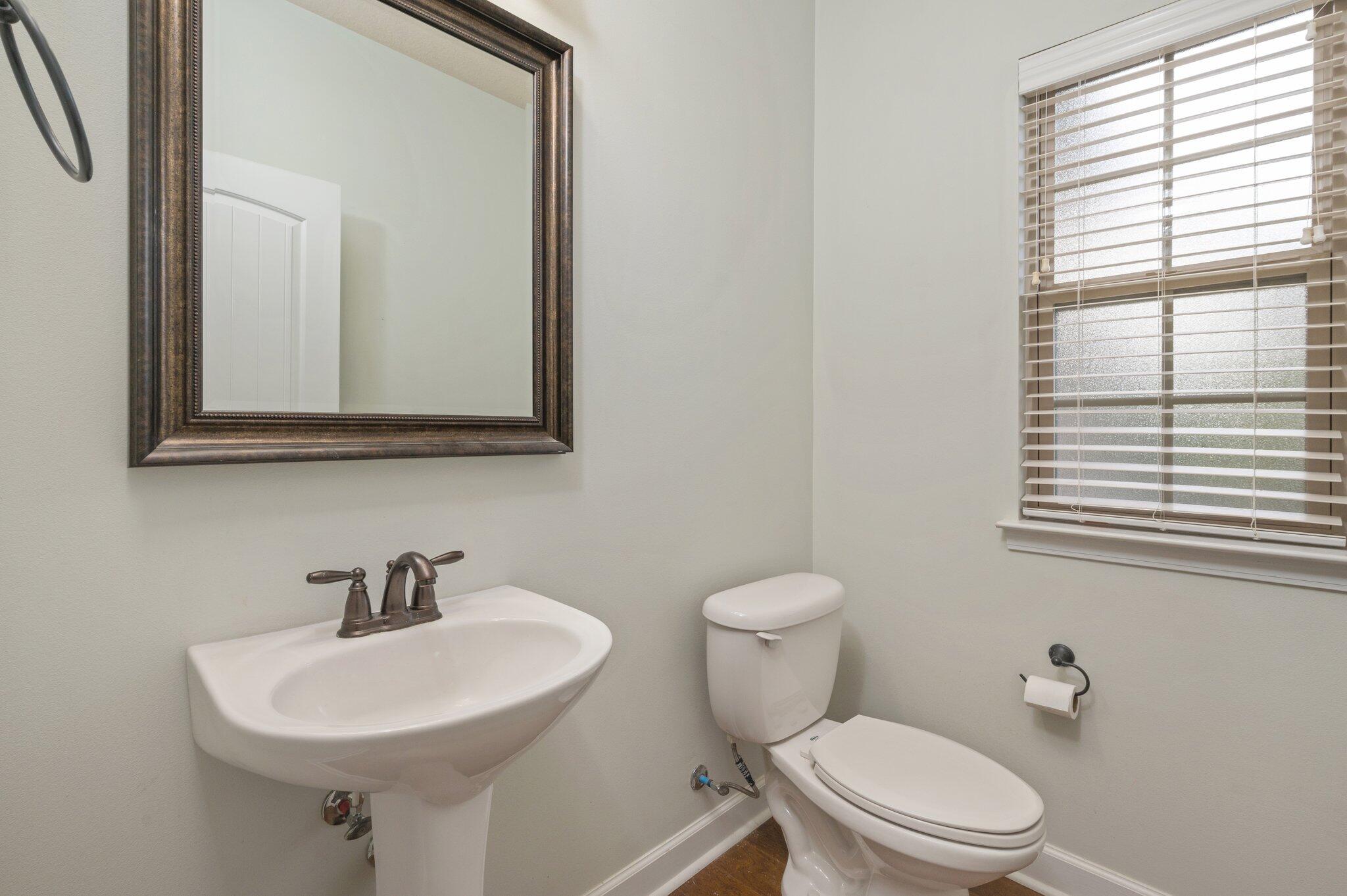 4434 Mirada Way Crestview, FL 32539 - Photo 37 of 42 a bathroom with a toilet a sink and a window