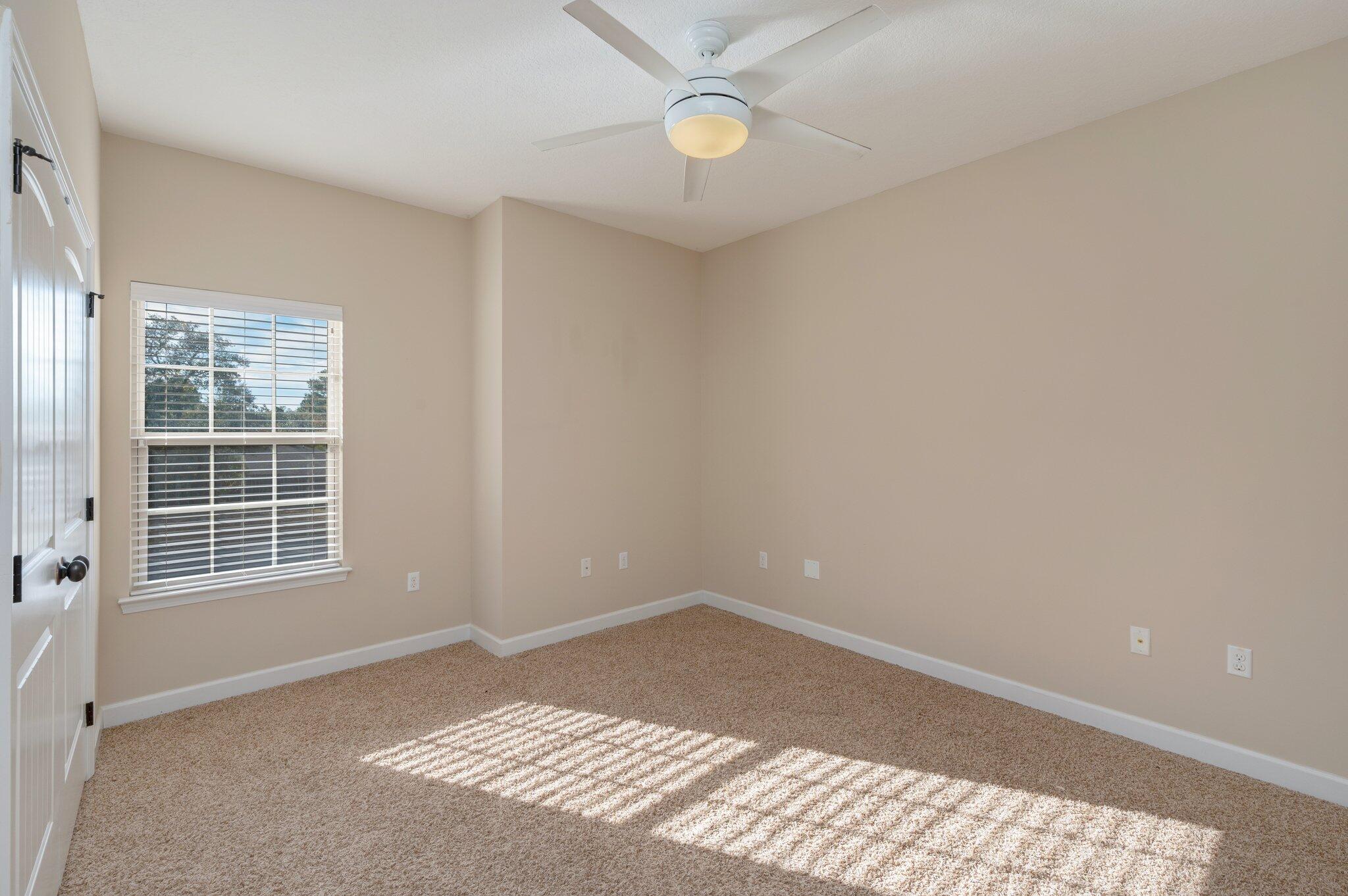 4434 Mirada Way Crestview, FL 32539 - Photo 5 of 42 an empty room with a window and ceiling fan