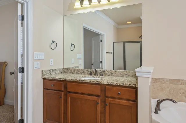 a bathroom with a granite countertop sink and a mirror