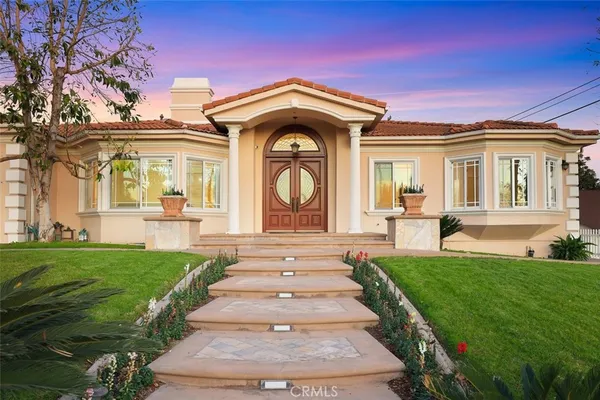 a front view of a house with a garden