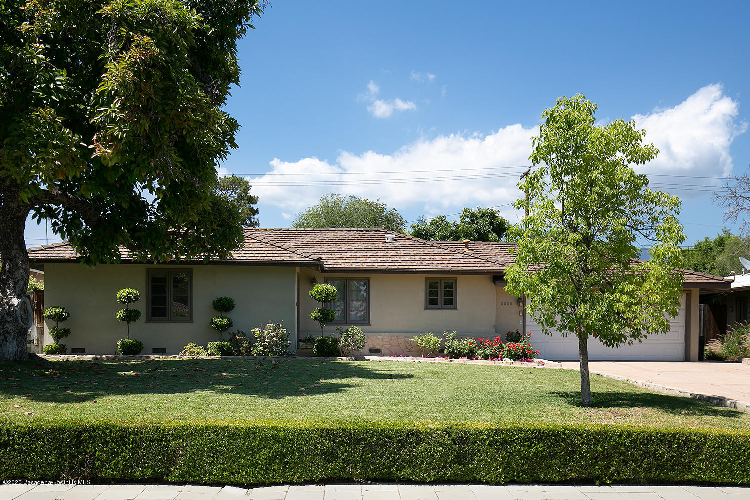 a front view of a house with garden