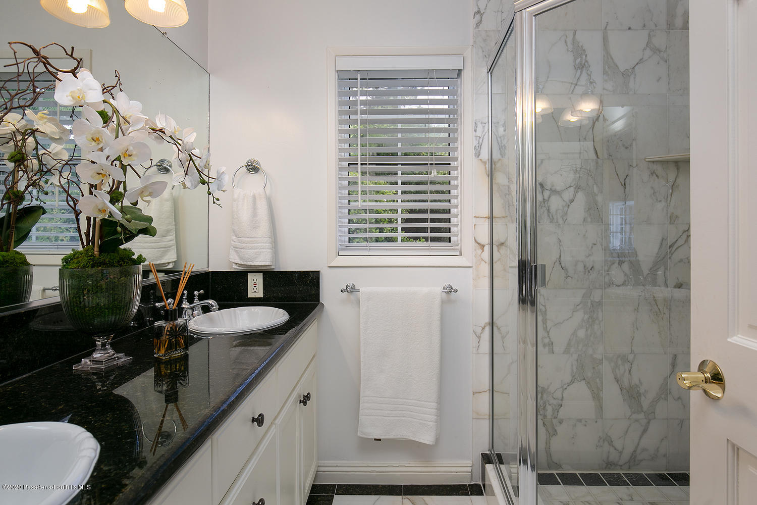 2855 Sheffield Road San Marino, CA 91108 - Photo 24 of 36 a bathroom with a granite countertop sink a toilet a mirror and shower