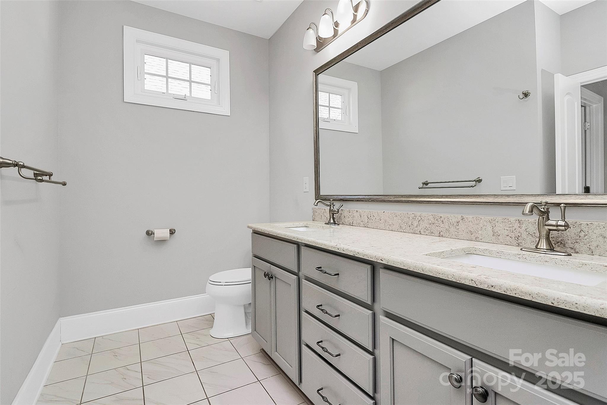 535 Chalmers Row Rock Hill, SC 29732 - Photo 21 of 38 a bathroom with a granite countertop sink a toilet and a mirror