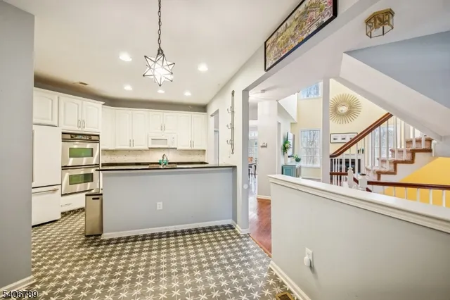 a kitchen with a refrigerator a sink and cabinets