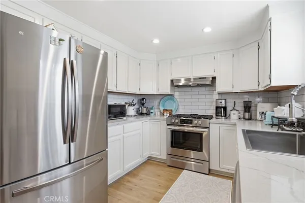 a kitchen with a sink and a stove top oven