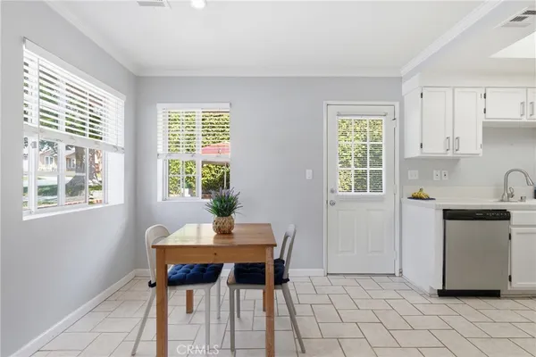 a kitchen with stainless steel appliances granite countertop a sink stove refrigerator and cabinets