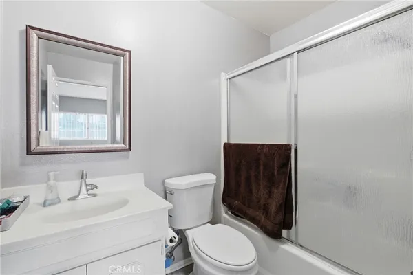 a bathroom with a sink a mirror and a shower