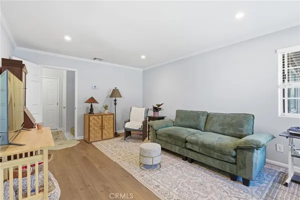 a living room with furniture wooden floor and a flat screen tv