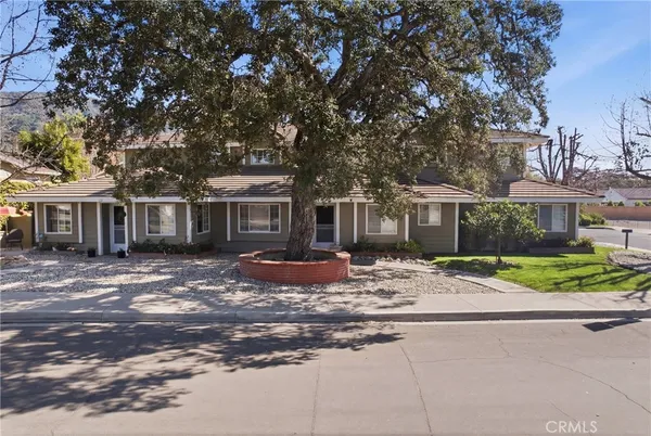 a view of a house with swimming pool and sitting area